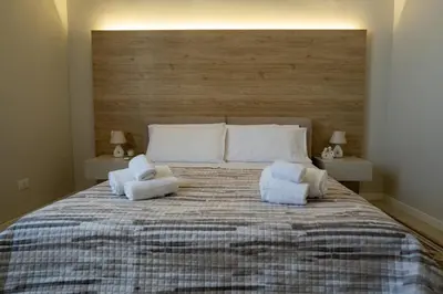 a bedroom with a large bed with towels on it at Casa del Porto in Castellammare del Golfo