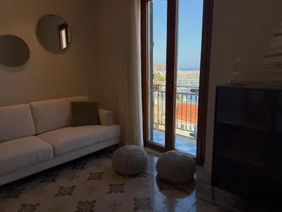 a table and chairs on a balcony with a view at Casa del Porto in Castellammare del Golfo