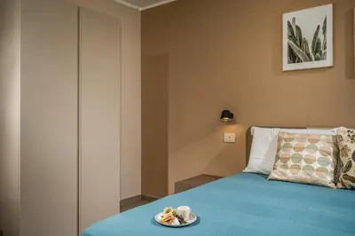 a bedroom with a bed with a plate of food on it at Villa Orizzonte in Scopello