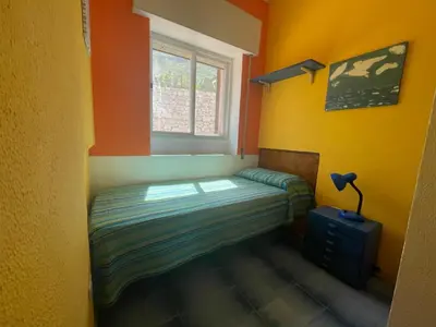 a small bedroom with a bed and a window at Villa Venere al Sauce - esclusiva villa sul mare in San Vito lo Capo