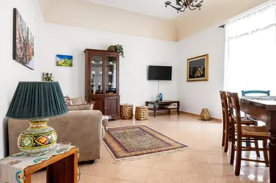 a living room with a couch and a table with a lamp at TorreKalsa Apartment by Wonderful Italy in Palermo