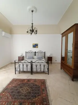 a bedroom with a bed and a chandelier at TorreKalsa Apartment by Wonderful Italy in Palermo