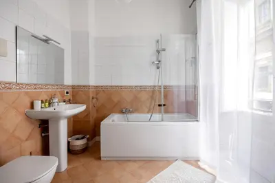 a bathroom with a tub and a toilet and a sink at TorreKalsa Apartment by Wonderful Italy in Palermo