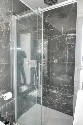 a shower with a glass door in a bathroom at Oasi Elegante Piscina di Lusso - vista panoramica By Sicily Home Solutions in Alcamo