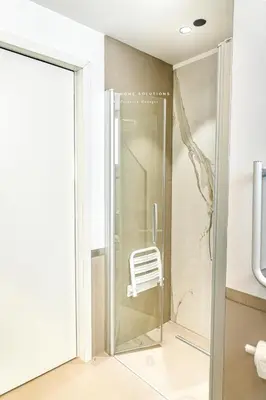 a glass shower door in a bathroom with a chair at Oasi Elegante Piscina di Lusso - vista panoramica By Sicily Home Solutions in Alcamo