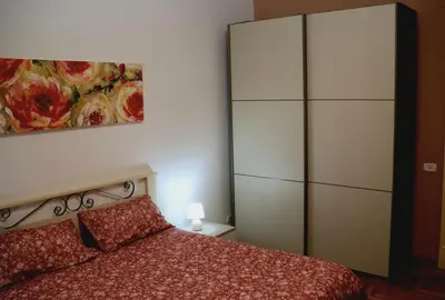 a bedroom with a bed and a large dresser at la casa di Tati Palermo centro in Palermo