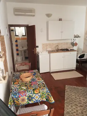 a kitchen with a table and a counter top at Tiny House in Palermo