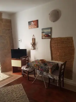 a dining room with a table and chairs and a desk at Tiny House in Palermo
