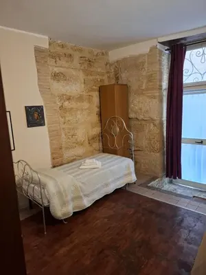 a bedroom with a bed in a room with a window at Tiny House in Palermo