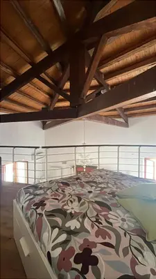 a bedroom with a bed with a floral comforter at I Tamarindi in Palermo