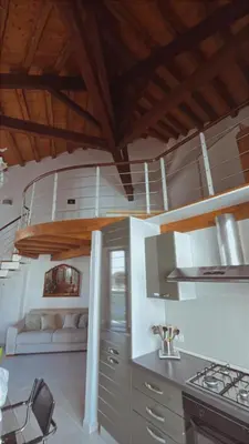 a kitchen with a stove and a couch in a room at I Tamarindi in Palermo