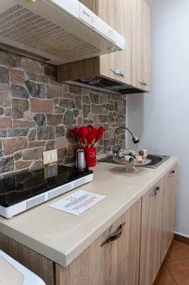 a kitchen with a counter and a stone wall at QuattroCantiApartment2 Palermo in Palermo