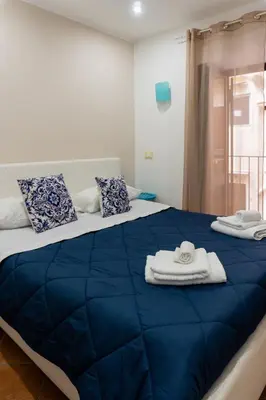 a large blue bed with towels on top of it at QuattroCantiApartment2 Palermo in Palermo