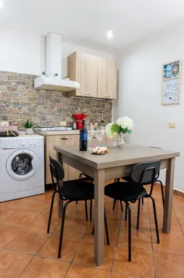 a kitchen with a table and chairs in a kitchen at QuattroCantiApartment2 Palermo in Palermo