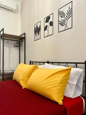 a bed with a yellow blanket on top of it at Casetta Bedda in Palermo