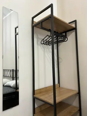 a shelf in a room with a mirror at Casetta Bedda in Palermo