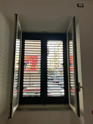 a window in a room with blinds at Casetta Bedda in Palermo