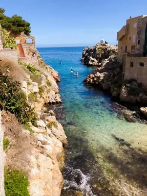 a group of people swimming in a body of water at Casa Maria Elena in Santa Flavia