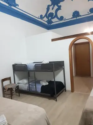 a bedroom with a bunk bed with a blue ceiling at Vucciria room in Palermo