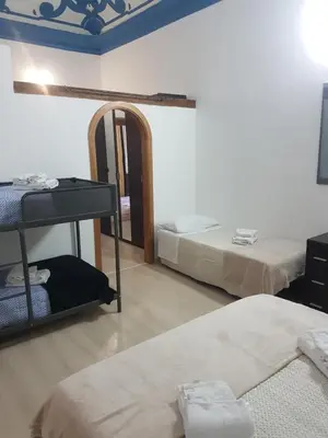 a room with two beds and a mirror at Vucciria room in Palermo