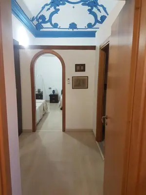 a hallway with a blue ceiling and a bedroom at Vucciria room in Palermo