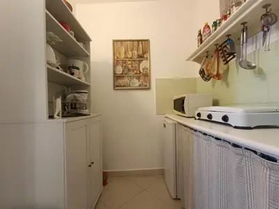 a kitchen with white cabinets and a counter top at Trip Rooms 2 in Palermo