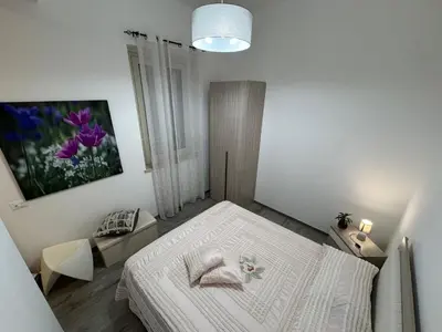 a white bedroom with a large white bed in it at La Dolcissima in Castellammare del Golfo