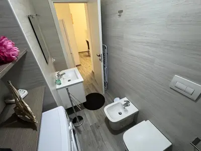 a bathroom with a white toilet and a sink at La Dolcissima in Castellammare del Golfo