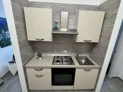 a small kitchen with a stove and a sink at La Dolcissima in Castellammare del Golfo