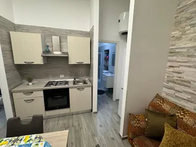 a kitchen with a sink and a stove top oven at La Dolcissima in Castellammare del Golfo