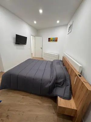 a bedroom with a large bed with a black blanket at Domus ad Max- La casa nel cuore di Palermo in Palermo