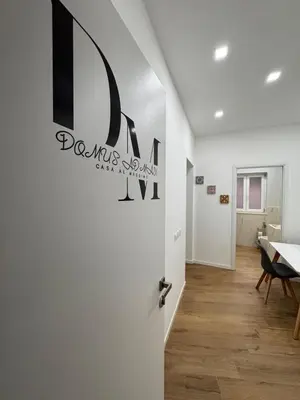 a room with a door with a sign on the wall at Domus ad Max- La casa nel cuore di Palermo in Palermo