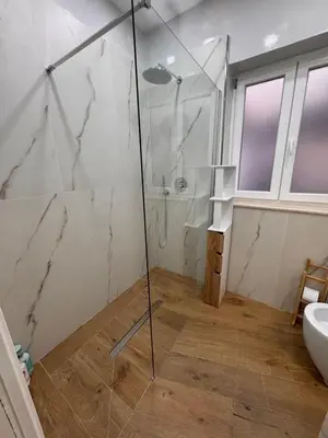 a bathroom with a shower and a toilet and a sink at Domus ad Max- La casa nel cuore di Palermo in Palermo