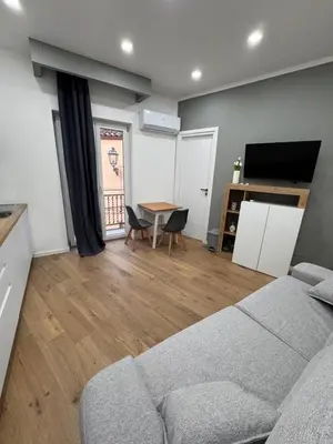 a living room with a couch and a table at Domus ad Max- La casa nel cuore di Palermo in Palermo