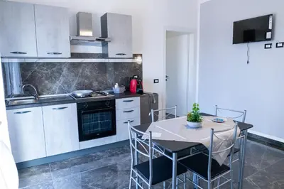 a kitchen with a table and chairs in a room at Cuor di Leone in Corleone