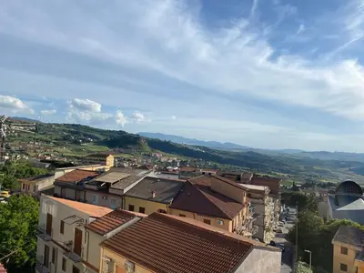 a city with buildings and mountains in the background at Cuor di Leone in Corleone