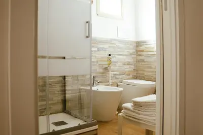 a bathroom with a shower and a toilet and a sink at Villa Torre Ulisse Locazione Turistica Affitti Brevi in Carini