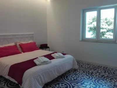 a bedroom with a bed with two towels on it at Capozafferano-Casa Carola in Santa Flavia