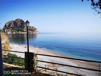 a street light on a beach next to a fence at Capozafferano-Casa Carola in Santa Flavia