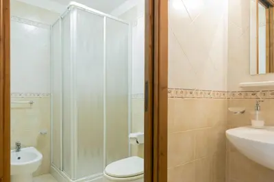 a bathroom with a shower and a toilet and a sink at Visitsicilia Le Magnolie in Castellammare del Golfo