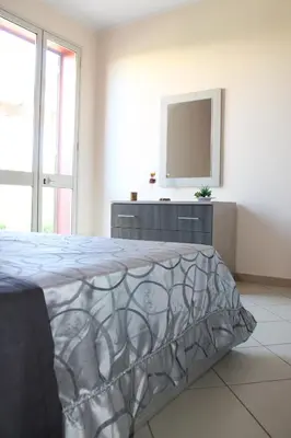 a bedroom with a bed and a tv on a wall at Ville Tiffany in Campofelice di Roccella