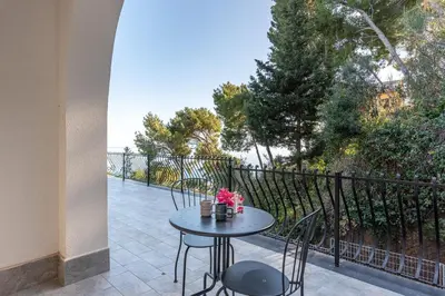 a table and chairs on a patio with a view at Villa con accesso al mare e vista mozzafiato in Palermo