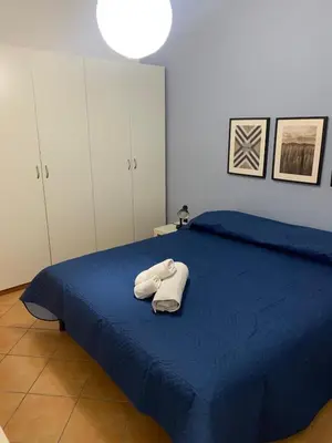 a bedroom with a blue bed with towels on it at La Casetta al Mercato del Capo in Palermo