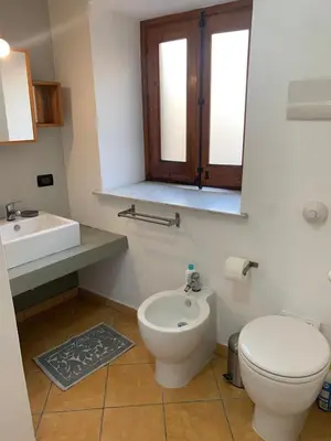 a bathroom with a toilet and a sink at La Casetta al Mercato del Capo in Palermo
