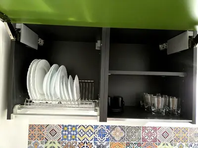 a shelf with plates and cups in a kitchen at Vicoletto Natalia - Proppro SRL- Palermo in Palermo