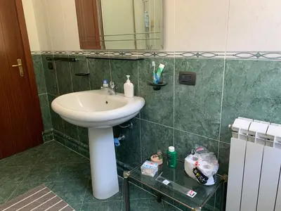 a bathroom with a sink and a mirror at Villino Toti e Silvana - a 50 mt dal mare in Carini