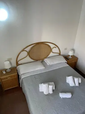 a bedroom with a bed with towels on it at Terrasini 2000 Casa Vacanze in Terrasini