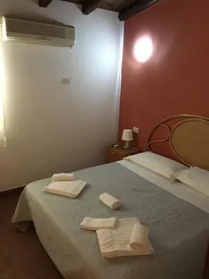 a bedroom with a bed with two towels on it at Terrasini 2000 Casa Vacanze in Terrasini
