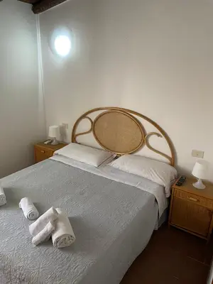a bedroom with a bed with towels on it at Terrasini 2000 Casa Vacanze in Terrasini