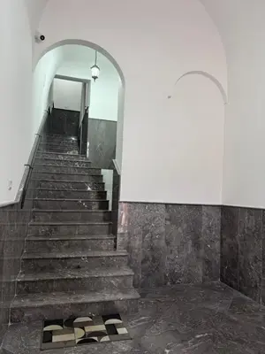 a staircase in a building with a white wall at Santa Rosalia Suites in Palermo